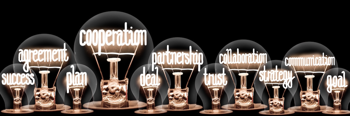 11 light globes with the words success, agreement, plan, cooperation, deal, partnership, trust, collaboraton, strategy, communication and gaol spelt out in the globes filament